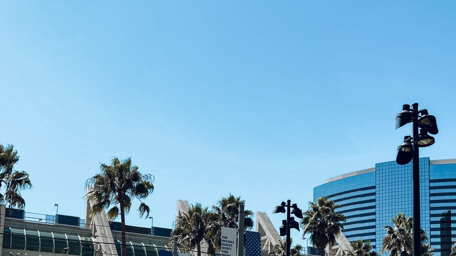 Modern convention center exterior with palm trees
