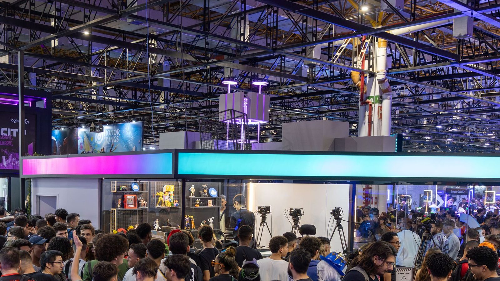 Crowded exhibition hall aisle under dramatic event lighting
