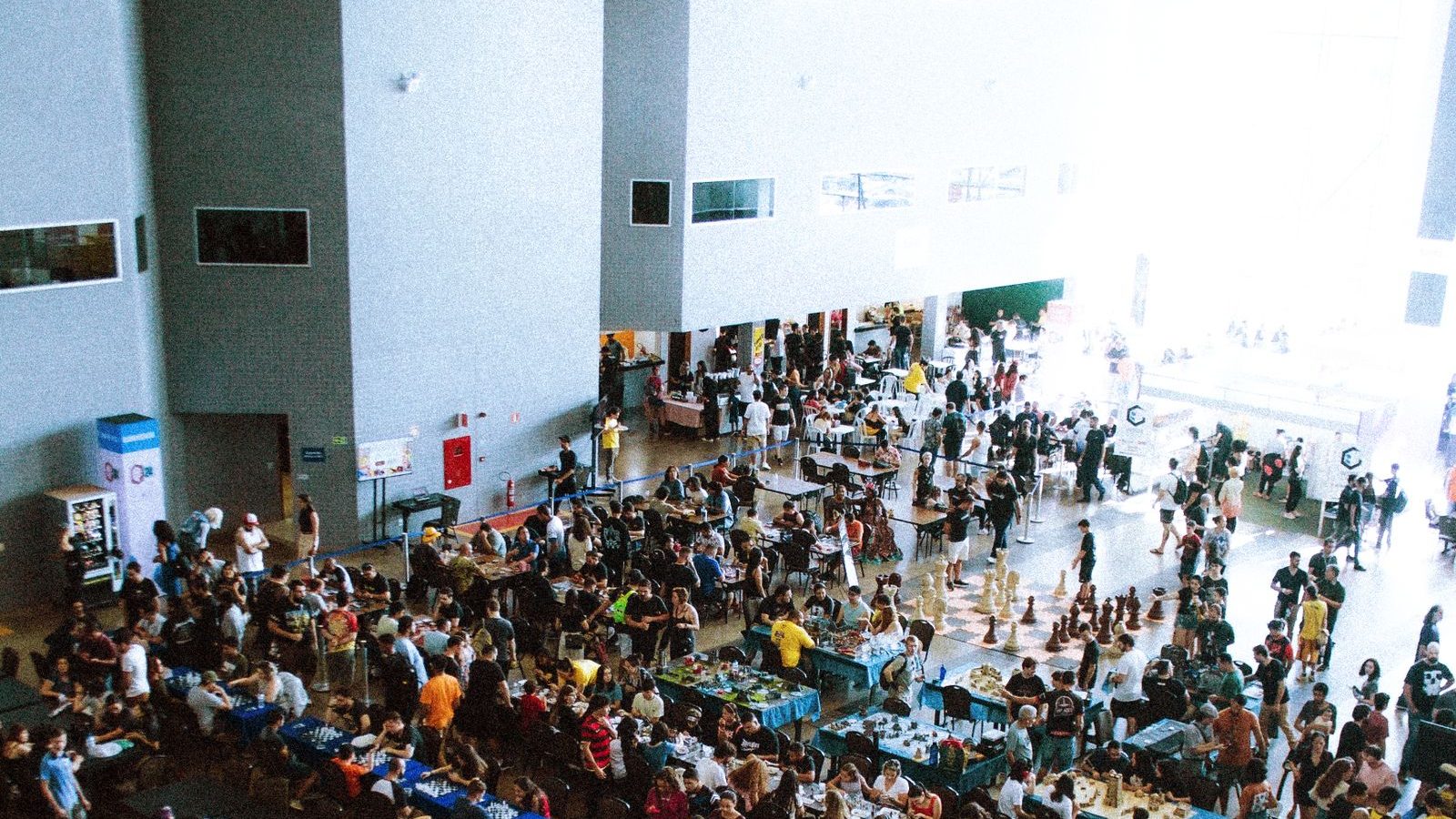 Crowd gathered on a busy convention center floor