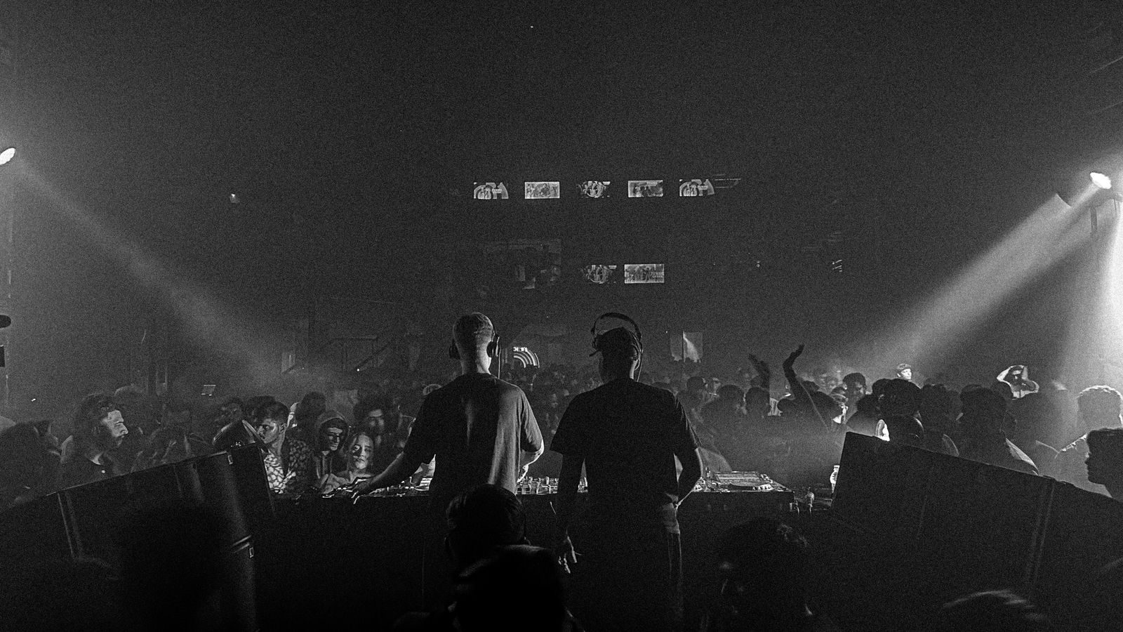 DJ performing to a full crowd in a nightclub