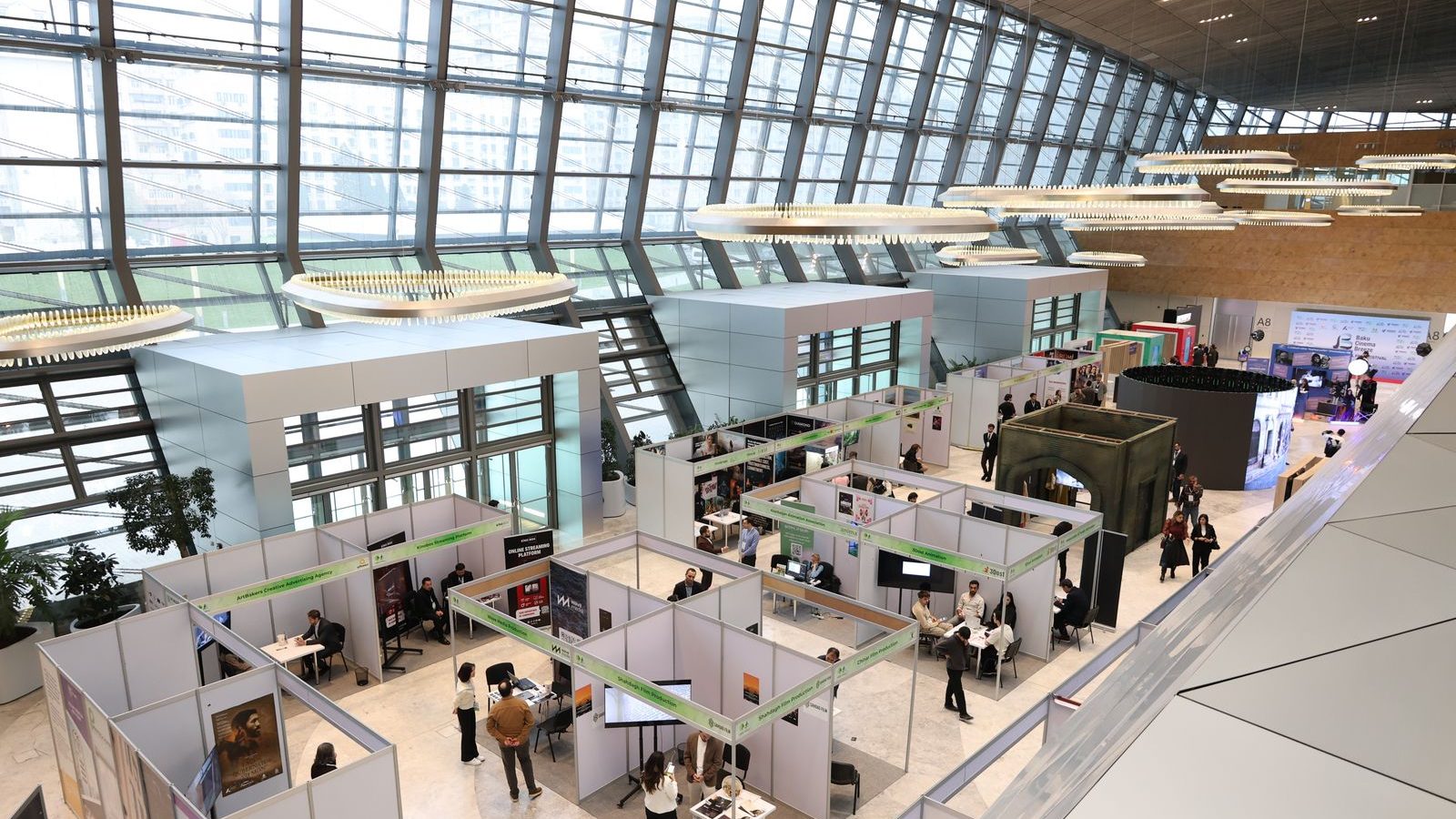 Attendees walking a modern trade show exhibition floor